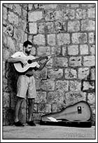 Man busking with guitar inside the old town#44; Dubrovnik, Croatia