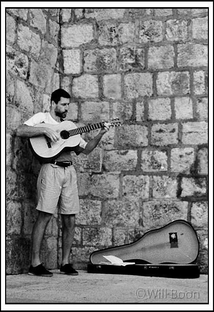 Man playing guitar inside the old town, Dubrovnik, Croatia