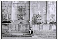 Young boy resting beside a water fountain, Dubrovnik