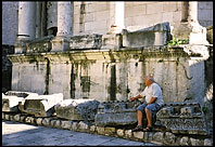 Man sitting on ruins of roman cathedral, Split
