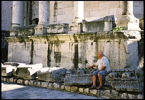Old man takes a rest on the ruins of a Roman Cathedral, Split