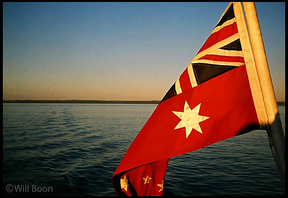 Australian flag at sunset, Fraser Island, Australia