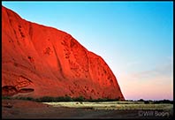 Early morning sun begins to rise over Uluru, Northern Territory, Australia