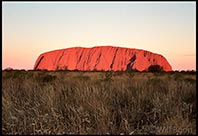 Sun beings to set over Uluru, Red Center, Australia