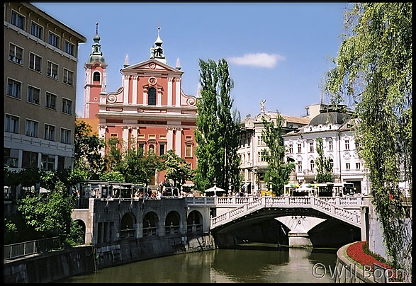 Ljubljanica river with the franciscan church in the distance, Ljubljana